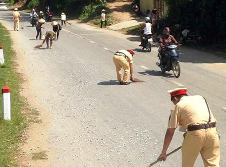 CSGT 'đội nắng' dọn đá dăm, nhặt cá giúp người dân