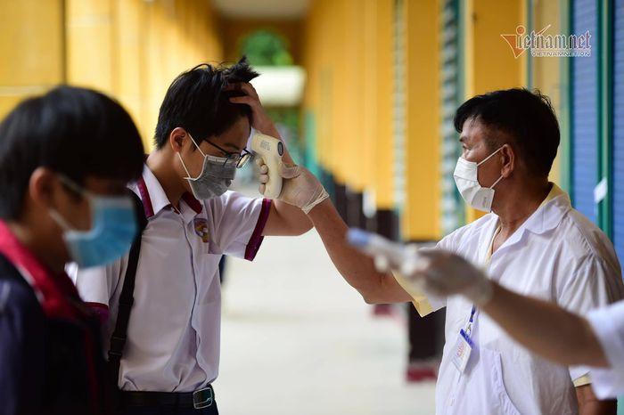 Thí sinh mang khẩu trang, kính chống giọt bắn làm thủ tục dự thi tốt nghiệp THPT