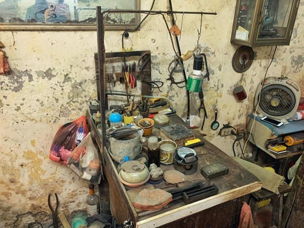 Những vật dụng đơn giản và thô sơ trên chiếc bàn cũ kĩ đã gắn bó với ông Thành từ lâu.