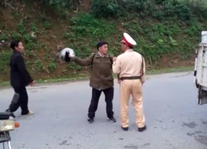 Dùng mũ bảo hiểm tấn công, chửi bới lực lượng chức năng (Ảnh cắt từ Clip).