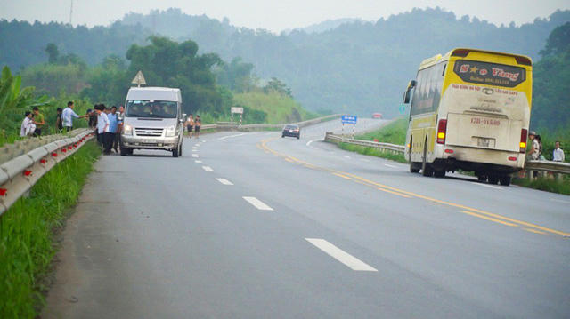 Còn tại km 224-225, đoạn qua địa phận tỉnh Lào Cai, cảnh bến dù xe cóc hoạt động tấp nập hơn. Nhiều tài xế dừng phương tiện 10-15 phút để chờ đợi hành khách, hàng hóa, người dân đi bộ dưới lòng đường, tạo nên một khung cảnh hỗn độn như... đường làng.