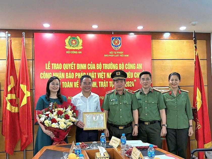Thiếu tướng Đinh Văn Nơi, Cục trưởng Cục A03 trao Quyết định của Bộ trưởng Bộ Công an tới lãnh đạo Báo Pháp luật Việt Nam.