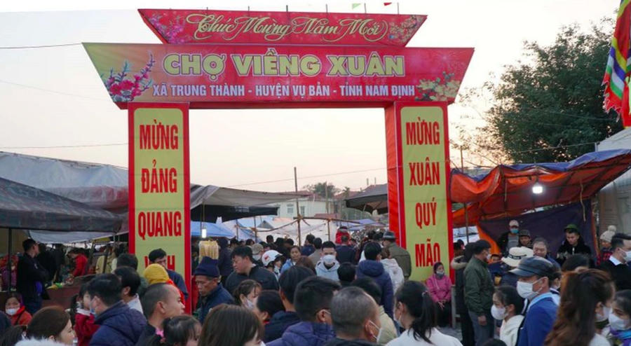 Các tuyến đường dẫn đến chợ Viềng đã chật cứng người và xe. Nhiều người phải gửi xe cách chợ cả 3, 4 km để chen chân vào chợ.