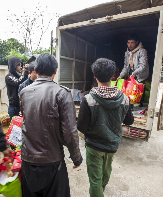 Chuyển quà Tết từ xe tải xuống để trao cho bà con. (Ảnh: Phạm Thanh Hà)