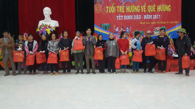 Phó chủ tịch Hoàng Văn Khuông và ông Vũ Huy Hoàn trao quà cho các hộ dân nghèo.