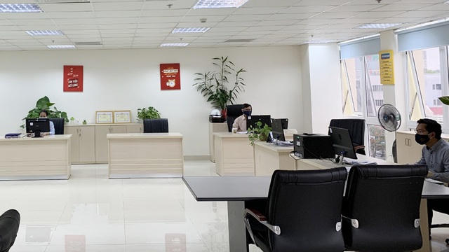 Cán bộ nhân viên Công ty CP Điện lực Thừa Thiên Huế làm việc giãn khoảng cách trong văn phòng với số lượng người ít, vị trí ngồi cách xa nhau, mở cửa sổ thông thoáng không dùng máy lạnh và toàn bộ đeo khẩu trang