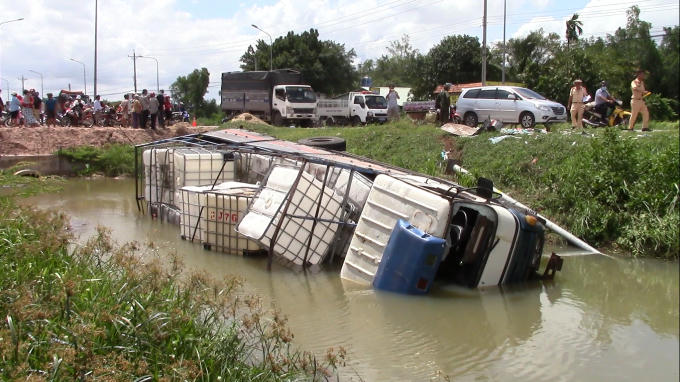 Xe tải bị tông rơi xuống mương nước.