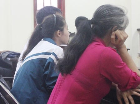 Hai mẹ con chị T. và cháu L. tại phiên tòa.