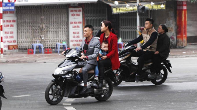 Người dân vô tư đi xe không đội mũ bảo hiểm trong những ngày Tết.