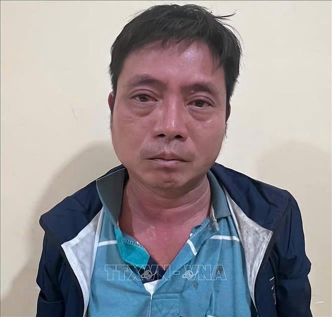 Đối tượng Đỗ Tuấn Anh tại cơ quan công an. Ảnh: TTXVN