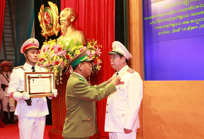 Trung tướng Somkeo Silavong, Bộ trưởng Bộ An ninh Cộng hòa DCND Lào gắn Huân chương Lao động hạng Nhì cho Thượng tướng Bùi Văn Nam, Ủy viên Trung ương Đảng, Thứ trưởng Bộ Công an Việt Nam.