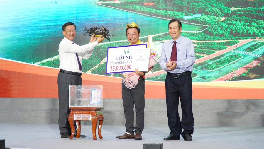Ông Hồ Trung Việt – Ủy viên Ban Thường vụ Tỉnh ủy, Trưởng Ban Tuyên giáo và Dân vận Tỉnh ủy Cà Mau trao chứng nhận cho đại diện Công ty TNHH Dư Thái Bình (ấp Kinh Tắc, xã Năm Căn, tỉnh Cà Mau), đơn vị có con cua nặng 1.889,2 gram, đạt giải Nhất cuộc thi cua có trọng lượng lớn nhất.