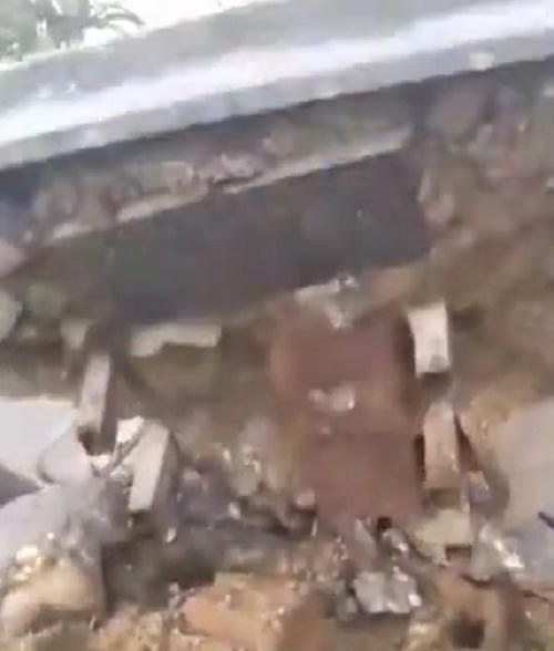 Cổng chào sau khi bị húc đổ lộ ra bên trong toàn cát đá. (Ảnh: Cắt từ clip)