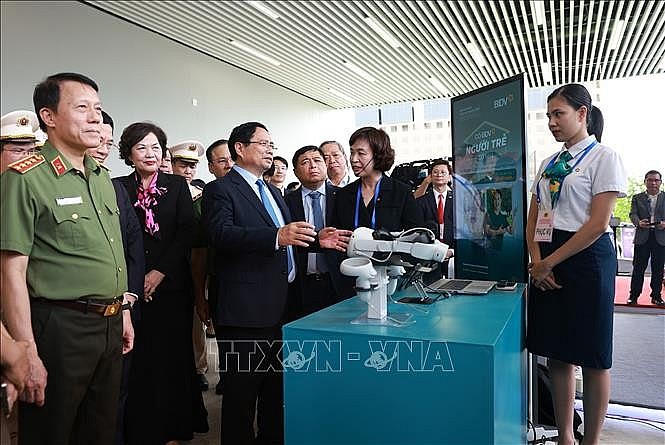 Thủ tướng Phạm Minh Chính tham quan gian hàng trưng bày sản phẩm công nghệ. Ảnh: TTXVN