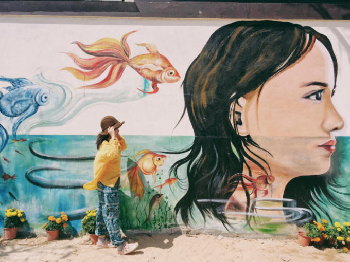 Các bức tranh ở làng bích họa Tam Thanh chủ yếu mô tả cuộc sống thường nhật của người dân làng chài hay những câu chuyện trẻ thơ gần gũi, giản dị với gam màu tươi, bắt mắt. Ảnh: Huong Mymy.