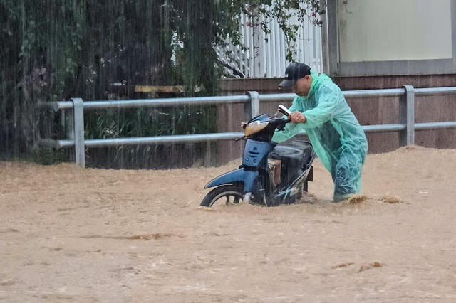 Đường ngập nước khiến việc đi lại của người dân gặp khó khăn.