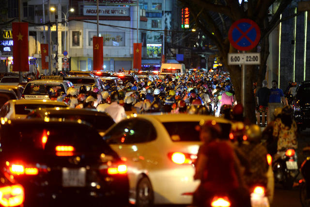 Ô tô, xe máy nối đuôi nhau trong biển người đầu năm mới.