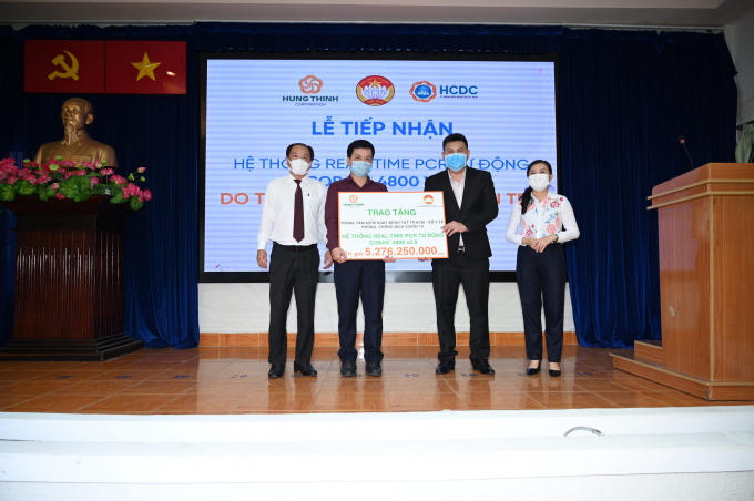 Ông Nguyễn Nam Hiền – Phó Tổng Giám đốc Tập đoàn Hưng Thịnh trao tặng hệ thống máy xét nghiệm tự động Real-time PCR cho Bác sĩ Nguyễn Hồng Tâm – Phó Giám đốc Trung tâm kiểm soát bệnh tật TP.HCM với sự chứng kiến của Bác sĩ Nguyễn Hoài Nam – Phó Giám đốc Sở Y tế TP.HCM và Bà Phan Kiều Thanh Hương – Phó Chủ tịch Ủy ban MTTQ Việt Nam TP.HCM