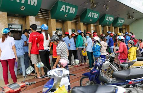 Càng về chiều, dòng người chờ rút ATM càng kéo dài thêm.