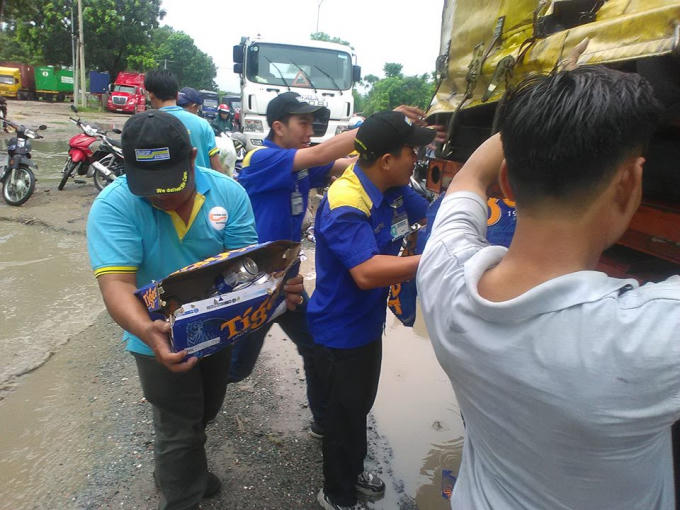 Nhiều người không lo ngại dơ bẩn đã lao ra phụ giúp tài xế. ảnh:Bảo Toàn.