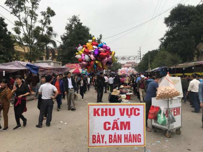 Mặc dù biển cấm bán hàng, các quầy hàng vẫn bày bán tràn lan.                                                        Những liền anh liền chị hát quan ho xin tiền du khách.