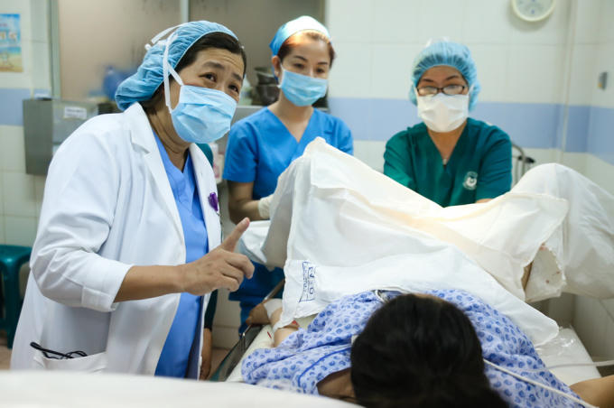 Khi sản phụ lên bàn sinh, bác sĩ Nguyễn Bá Mỹ Nhi, Phó giám đốc bệnh viện Từ Dũ và các y tá điều dưỡng hướng dẫn bệnh nhân cách thở để sinh em bé một cách thuận lợi.