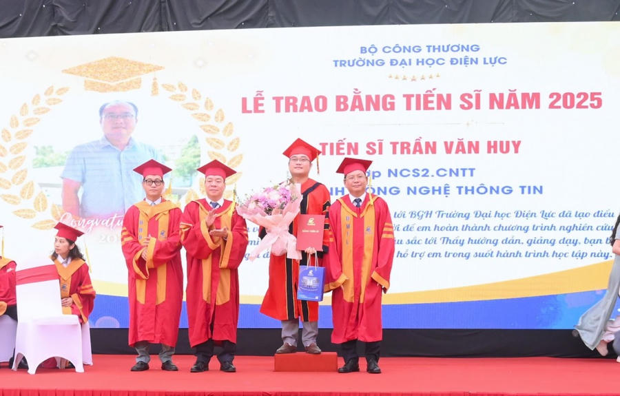 NGƯT.PGS.TS Vũ Đình Ngọ - Bí thư Đảng ủy, Chủ tịch Hội đồng Trường; PGS.TS Đinh Văn Châu - Phó Bí thư Đảng ủy, Hiệu trưởng Nhà trường tặng hoa và trao bằng cho tân tiến sĩ. (Ảnh: epu.edu.vn)