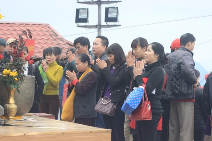 Du khách thắp hương cầu phật trước tượng Phật Hoàng Trần Nhân Tông.