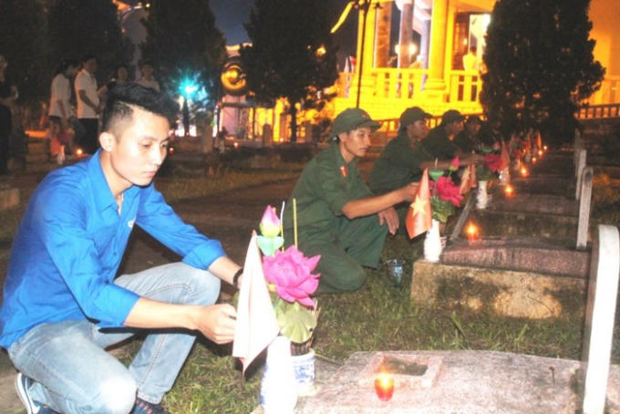 Thắp nến tri ân các Anh hùng liệt sĩ đang yên nghỉ tại Nghĩa trang quốc tế Việt – Lào. Ảnh: Ngọc Thăng