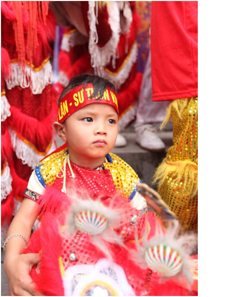 Hình ảnh một em bé trong đoàn múa Lân