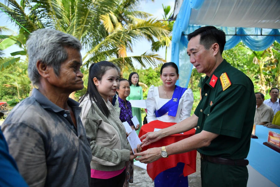 Đại tá Cao Minh Tâm, Phó Chính ủy Bộ CHQS tỉnh trao quà hỗ trợ cho người dân.