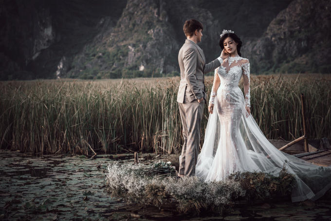 Vẫn gam màu trắng tin khôi, nhà thiết kế sử dụng chất liệu ren đắp nổi, tạo thêm điểm nhấn cho bộ váy.