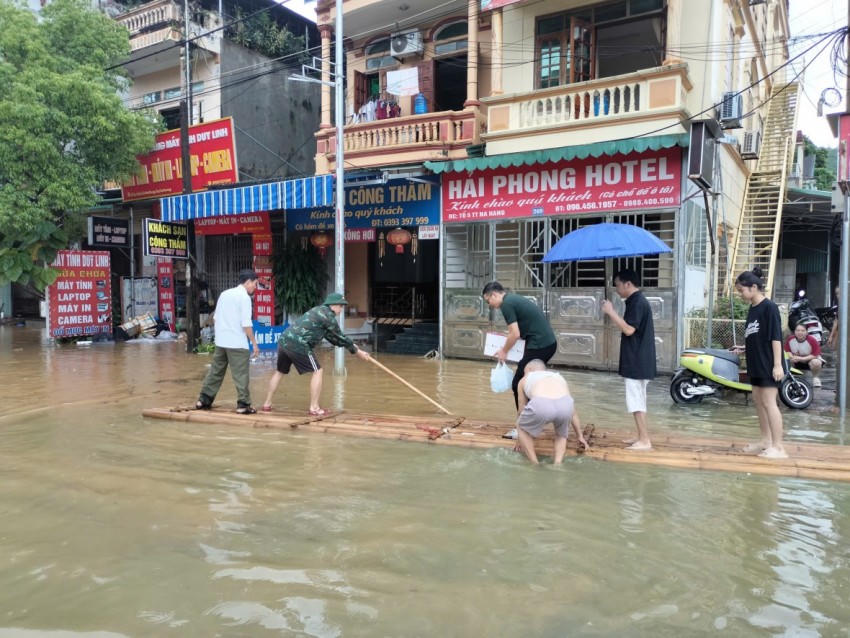 Lũ lên nhanh, các hộ dân ở xã Nà Hang tạo bè mảng để vận chuyển đồ đạc, tài sản. (Ảnh: Thái Sơn).