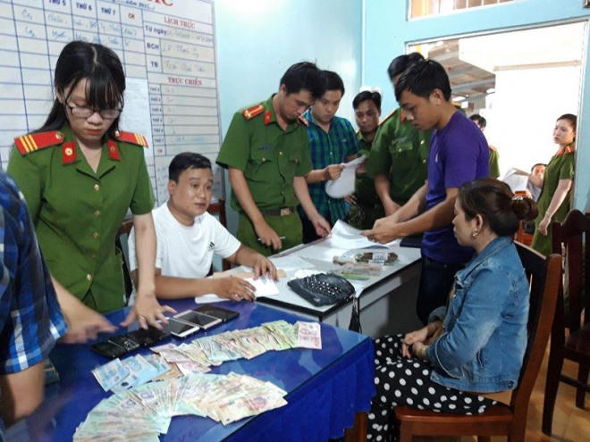 Công an kiểm tra các tang vật bị thu giữ trong vụ đánh bạc.