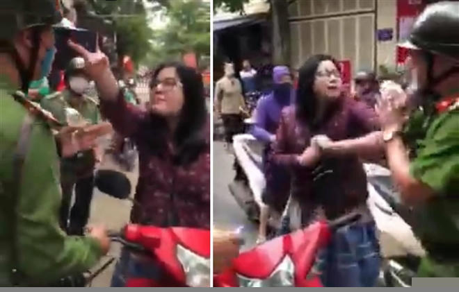 Người phụ nữ có hành vi chống người thi hành công vụ. (Ảnh cắt từ clip)