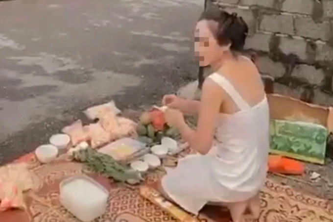 Người phụ nữ thắp hương cúng trước nhà