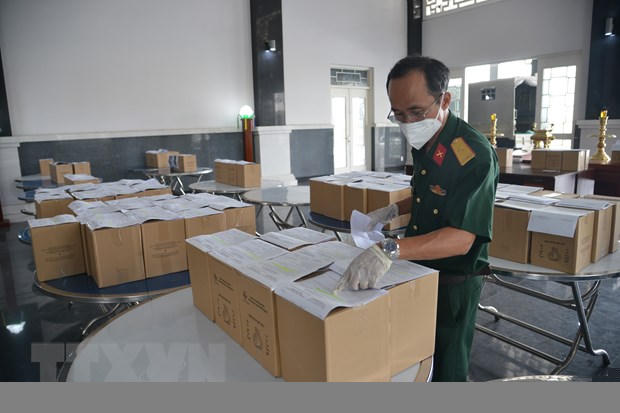 Cán bộ Bộ Tư lệnh TP Hồ Chí Minh kiểm tra tro cốt người mắc bệnh COVID-19 tử vong tại Nhà tang lễ Thành phố Hồ Chí Minh trước khi giao về nhà cho thân nhân. (Ảnh: Mạnh Linh/TTXVN)