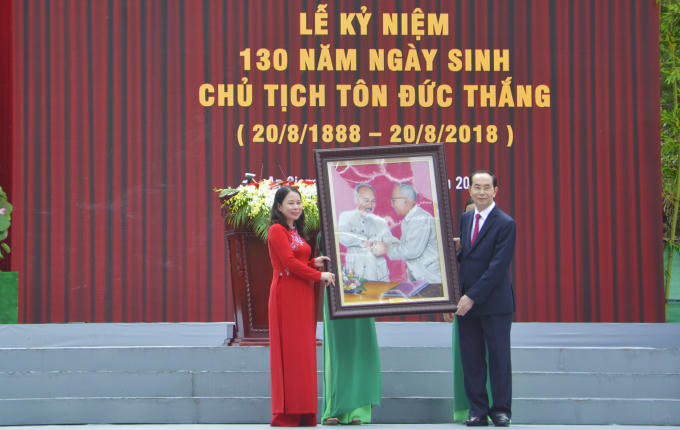 Chủ tịch nước Trần Đại Quang (bên phải) tặng bức tranh Bác Hồ với Bác Tôn cho Đảng bộ, chính quyền và nhân dân các dân tộc tỉnh An Giang.