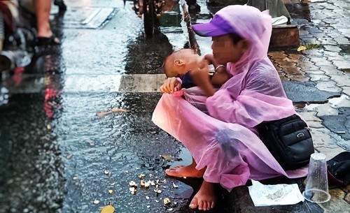 Một đứa trẻ được người lớn bế ra ngã tư đường để xin tiền (ảnh minh họa)