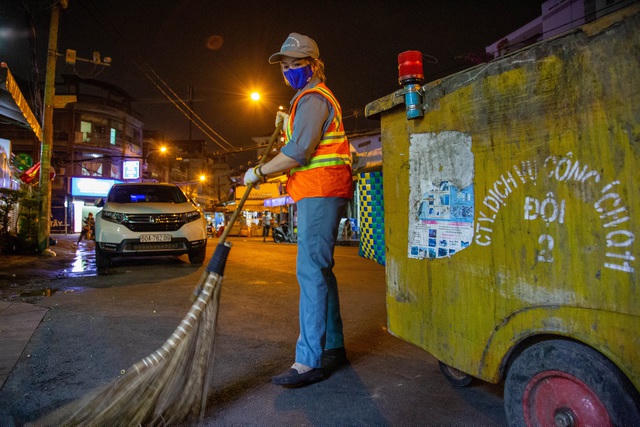 Nữ công nhân quét rác Kim Thị Hồng đang miệt mài với công việc ngay trước thời khắc giao thừa. 