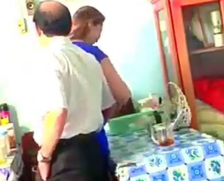 Hình cắt từ clip cho thấy ông Tấn ôm chị tạp vụ.