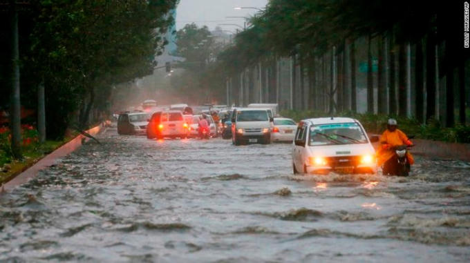 Xe cộ đang cố di chuyển trên đoạn đường ngập nước ở Manila.