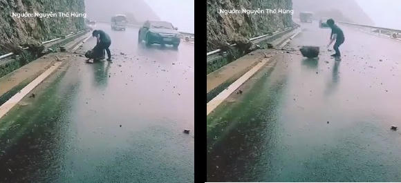 Người thanh niên đội mưa đẩy viên đá vào lề đường.