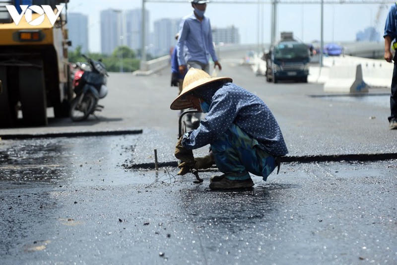 Công nhân đội nắng thi công mặt cầu để đảm bảo theo đúng tiến độ.