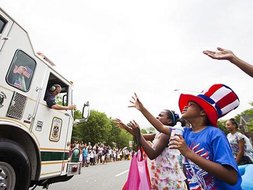 Các em bé háo hức chờ nhận kẹo trong ngày Độc lập.
