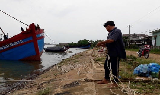 Một người dân đưa tàu vào nơi neo đậu.