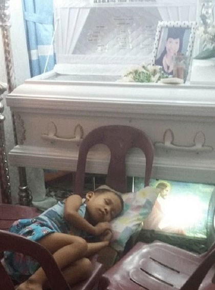 Cậu bé xếp ghế nằm cạnh quan tài mẹ trước ngày đưa tang.Ảnh letribunaldunet.