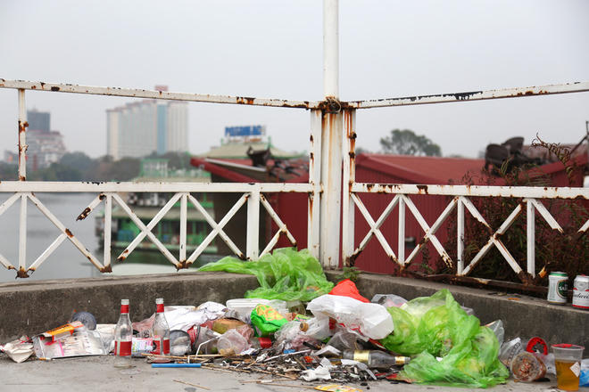 Người dân tập kết rác trên nóc ngôi nhà hoang ở ven hồ.