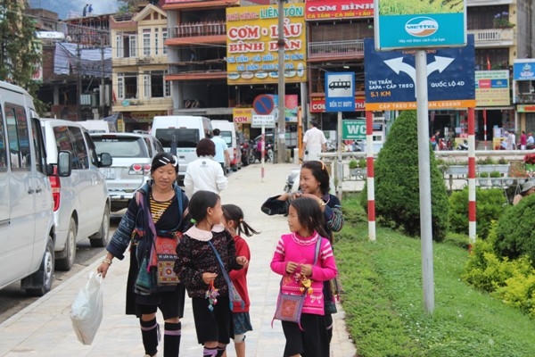 Những cô bé người Hmông theo mẹ ra thị trấn bán hàng lưu niệm.