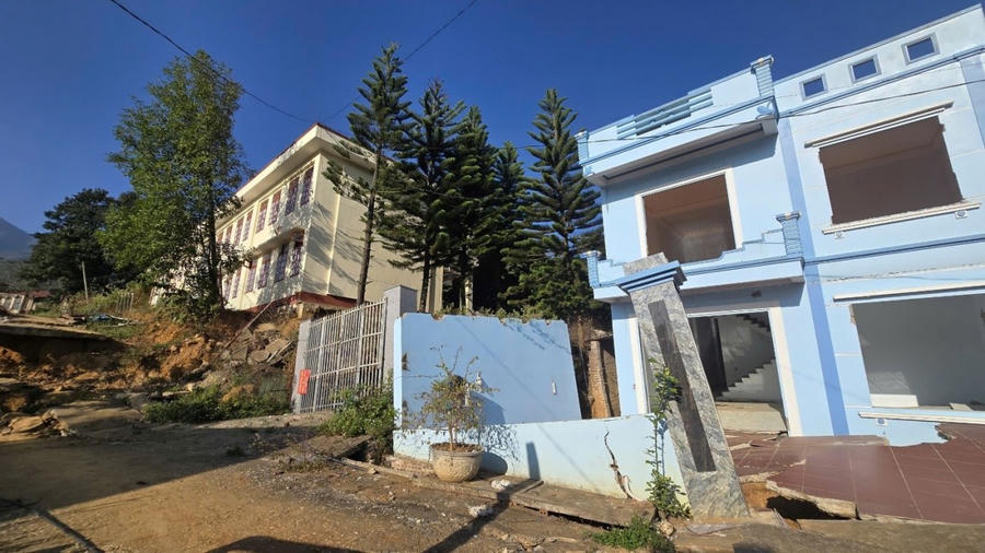 Ngôi nhà anh Đinh Văn Linh (bên phải) bị thiệt hại nặng nề sau cơn bão số 3, phải di dời đi nơi khác.